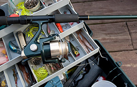 Fishing pole sitting on a tackle box