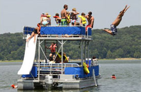 People having a great time sliding off the top of the double decker.